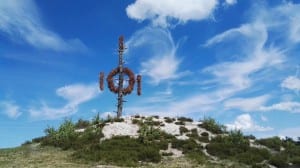 Wooden sculpture on a hill under a blue sky